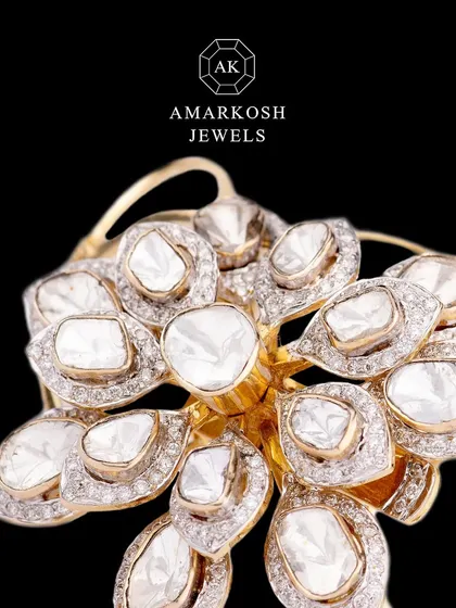 A close-up of the convertible diamond ring and bracelet, showing the intricate floral design made with large, flat-cut polki diamonds.