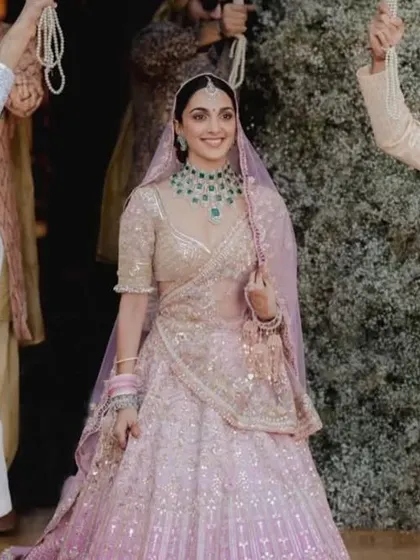 Kiara Advani's ombre pink wedding lehenga was a dream. I can work with you to create a custom lehenga with a similar beautiful color gradient and delicate embellishments.