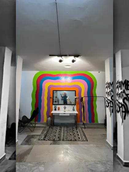 A wider view of the rainbow mural set, showing how it transforms the studio space. The clean lines and bright colors make it a versatile background for various photography styles.