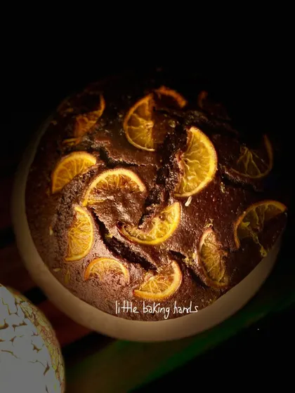 The dramatic lighting in this shot really highlights the deep, dark colour of the chocolate orange cake and the glistening orange slices on top.
