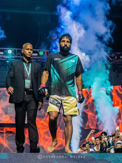 The walkout. Sanjeet Budhwar enters the cage, carrying the hopes of his team and fans. This is the calm before the storm.
