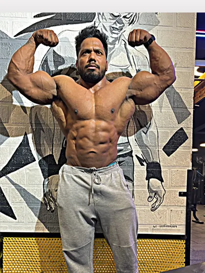 My muscles are sore, but my heart is happy. A front double bicep pose.