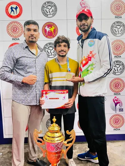 Posing with a gold medalist at the 16th Karnataka State Kickboxing Championship. As a coach, seeing my students succeed is the greatest reward.