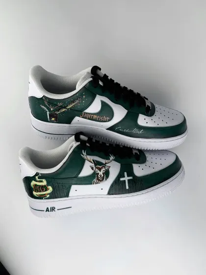 A complete overview of both shoes in the Jägermeister pair. This image captures all the different design elements together, from the logo on one side to the stag emblem on the other.