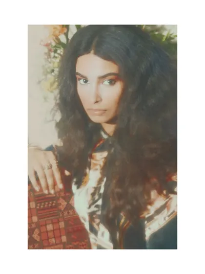 A direct and intimate portrait from "Roots." The focus is on the subject's expression, inviting a personal connection to the editorial's theme of heritage and identity.