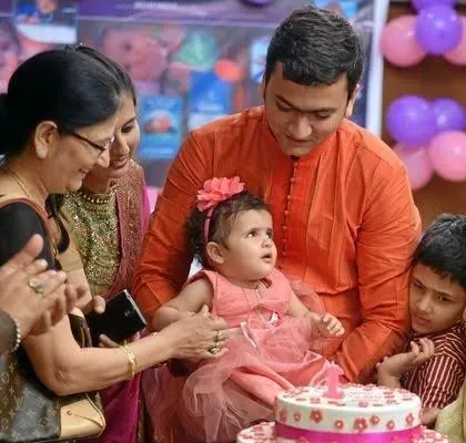 A closer look at the birthday girl's fascination with her cake. These candid shots are often the most cherished memories from an event.