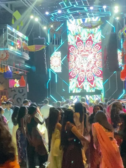 The dance floor is full of people performing Garba, with my custom visuals lighting up the stage. The combination of traditional dance and modern production is what makes these nights special.