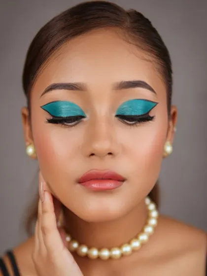 A full-on view of the graphic teal eyeshadow, showcasing its sharp lines and intense pigmentation.