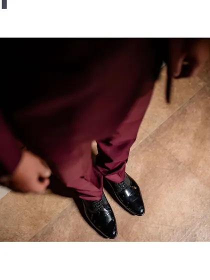 A detail shot of the groom's shoes and trousers.