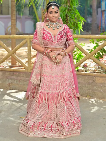 A confident pose from the bride, showcasing her stunning outfit and flawless makeup.