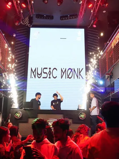 The stage is set with my 'Music Monk' branding and sparklers going off. I bring a professional and high-energy setup perfect for corporate events that want a club atmosphere.