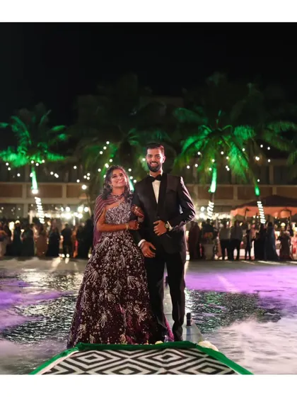 The couple's grand entrance over a pool at their reception. The combination of water, smoke, and dramatic lighting makes for a stunning and unique visual.