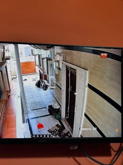 This camera is positioned to monitor the passageway next to the house, an important area for security.