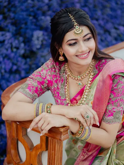 A happy, smiling portrait of the bride. The makeup is fresh and radiant, perfect for capturing the joy of her special day.