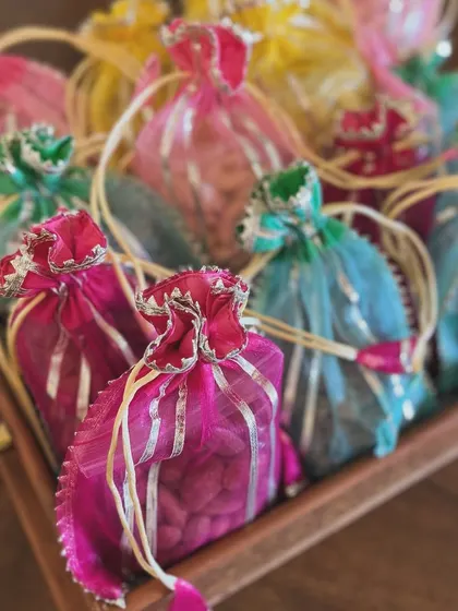 A tray of vibrant potlis, ready to be assembled into bespoke festive hampers.