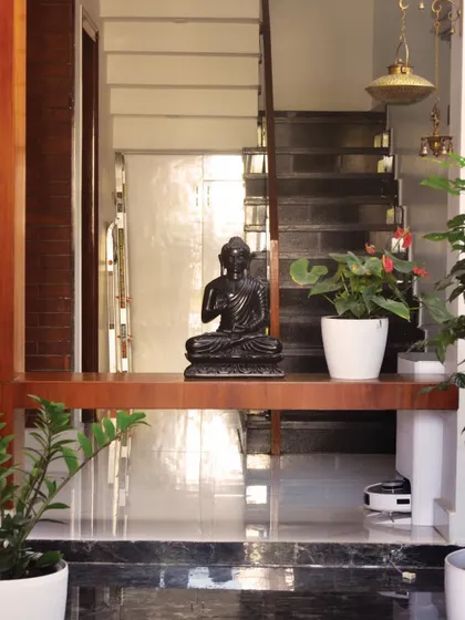 A detail from the Haritha and Harinath residence, where the staircase landing is used to display a serene Buddha statue. We often incorporate such niches for personal artifacts within our architectural designs.