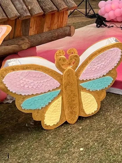 A custom-made butterfly piñata, beautifully decorated in pastel colors to match the party's theme before the fun begins.