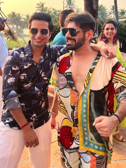 Making hay while the sun shines in Goa. Posing with a friend at a beautiful destination wedding, surrounded by exuberant people.