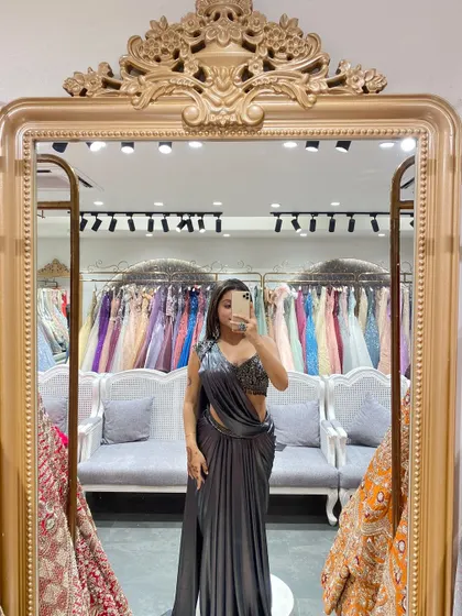 A mirror selfie showing off this stunning grey pre-draped saree with a heavily embellished blouse. Perfect for the festive season.