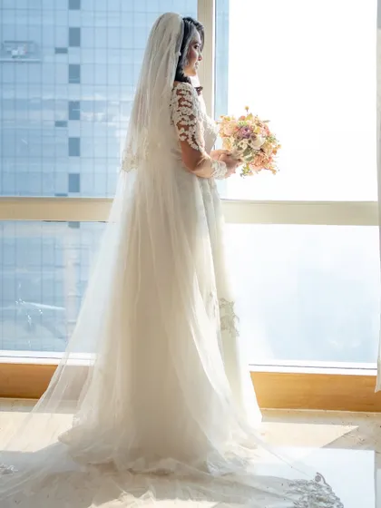 A full-length shot showing Irene's beautiful gown and long, flowing veil. Her hair and makeup complete the angelic picture.