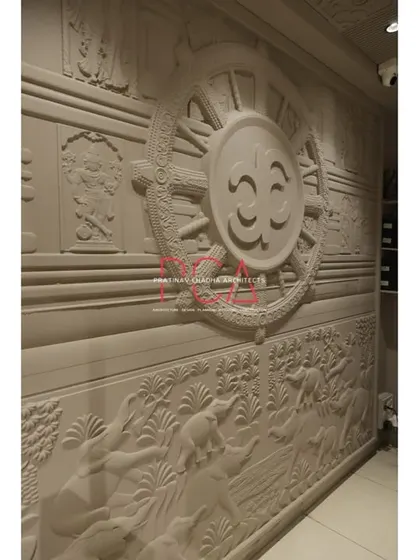 A close-up of another intricately carved wall panel in the Jubinav Chadha studio, inspired by the Konark Sun Temple.
