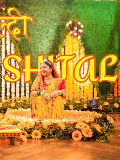 A portrait of the bride, Shital, seated amidst a beautiful floral Haldi setup. This showcases the decor and the bride's happy anticipation.