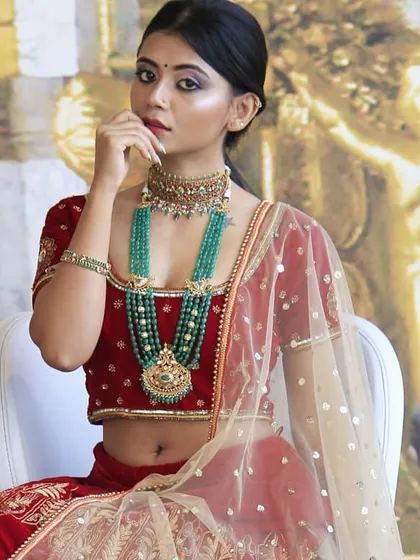 This angle shows the beautiful fit of the red velvet blouse and the way the sheer dupatta drapes gracefully. Every detail, from the cut to the embroidery, is designed to make a bride feel her absolute best.