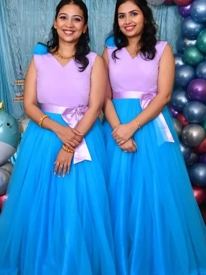 Two women in matching lavender and blue gowns, showing how the design works for adults as well.