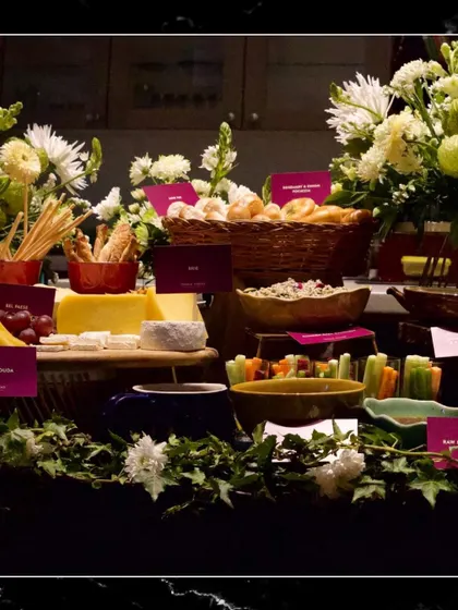 A beautifully arranged buffet table with fresh flowers, showcasing a variety of dishes for guests to enjoy.