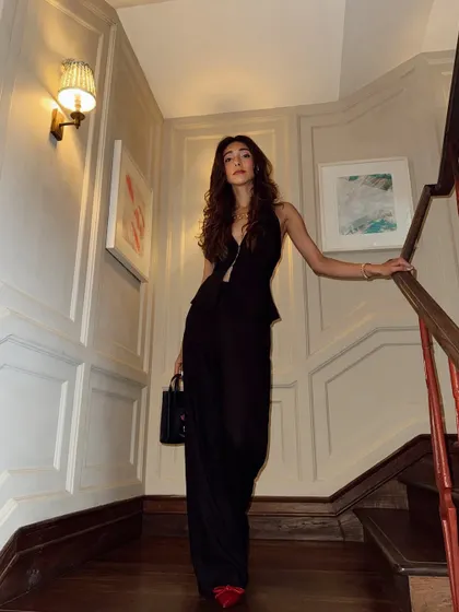 A chic all-black outfit with a pop of red for a gig. Sometimes a simple, powerful look is all you need.
