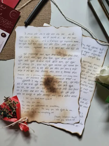 A letter written in a mix of Hindi and English on aged paper, accompanied by a tiny dried flower bouquet. It’s a perfect blend of modern love and vintage style.