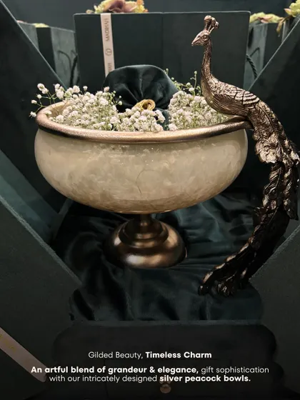 An artful blend of grandeur and elegance. This graphic highlights my intricately designed silver peacock bowl, a piece that adds sophistication to any hamper or home.