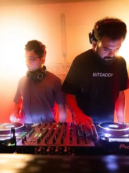 Another dynamic duo on the decks, with one DJ wearing a "Bitdaddy" shirt, adding a touch of personality to the underground music scene we foster.