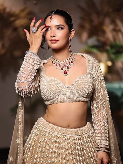 A confident and poised look, showing the full effect of the glamorous makeup and the stunning, modern ethnic wear.