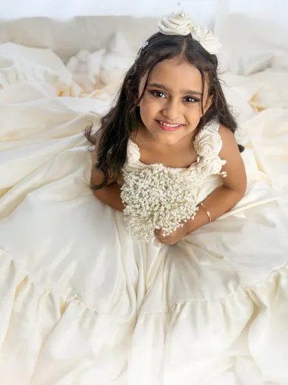 A lovely overhead shot looking directly at the camera. Her beautiful dress and sweet smile make this a standout portrait.