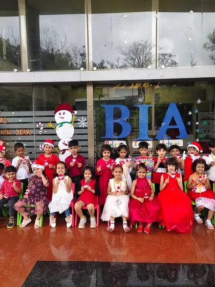 Our preschoolers and their teachers, all dressed in festive red, pose for a group photo to celebrate Christmas.