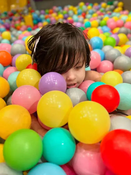 Peeking through the colorful balls. The ball pit is a place of endless discovery and play.