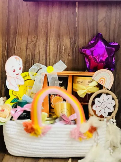 Another angle of the vibrant, rainbow-themed mom-to-be hamper, showing the full arrangement of gifts in the lovely white basket.