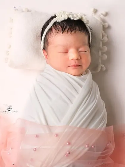 A pretty little doll in pink and white. The simple wrap and delicate tulle fabric create a soft, angelic look that is absolutely timeless.