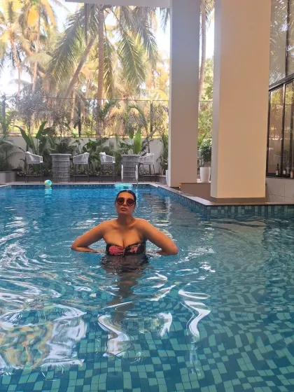 Another shot from the pool in Goa, showcasing a confident and relaxed moment. The tropical background adds to the holiday feel.