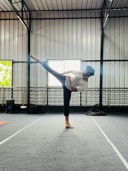 This student demonstrates a high, controlled kick, a testament to his flexibility and strength training.