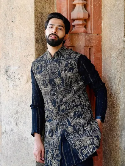 Leaning against a historic wall, the outfit feels perfectly at home. The traditional motifs on the Nehru jacket are a nod to our rich cultural roots, updated for the modern man.