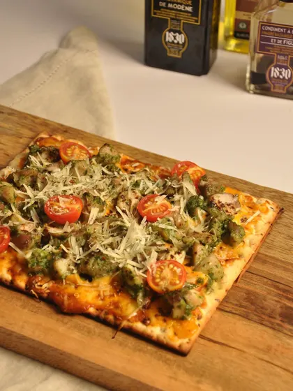 My Chicken Genovese flatbread features tender chicken and pesto on a crispy base, topped with grated Grana Padano cheese. It's a delicious fusion of Italian flavors.