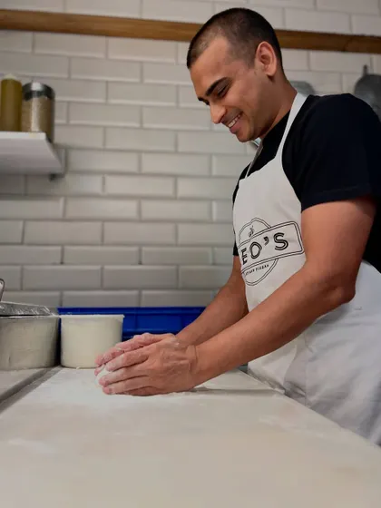 It begins with a simple ball of dough. Our pizzaiolo, Amol, carefully works the dough, a craft we've honed over years to achieve the perfect texture and flavour.