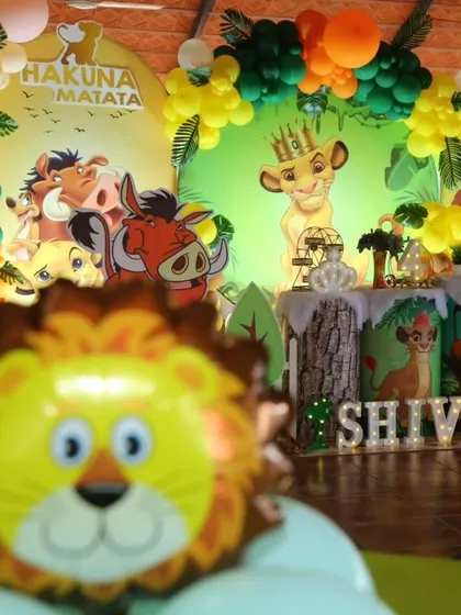 A creative close-up of the Lion King party with a lion balloon in the foreground.