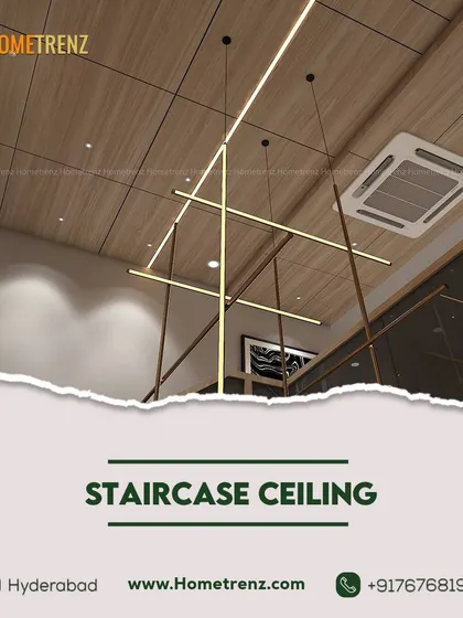 Reaching new heights. The ceiling above this staircase features a modern, linear chandelier set against a wooden panel, turning a transitional space into a design moment.