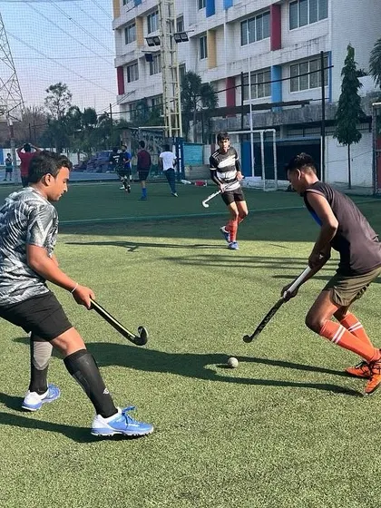 Two players face off in a practice drill, demonstrating the fundamental skills of tackling and defending. We focus on building a strong foundation for all our athletes.