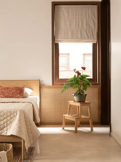 We used cane paneling and a warm, earthy color palette to make the guest room feel like a quiet retreat. The space is designed to be understated yet full of warmth and texture.