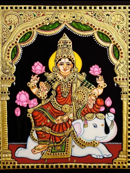 This exquisite Tanjore painting shows Goddess Lakshmi seated on the divine white elephant, Airavata. It is a unique and powerful depiction symbolizing immense prosperity and royal grace.