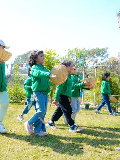 A teacher encourages the students as they set off with their baskets. Our staff is always on hand to guide and assist during school visits.